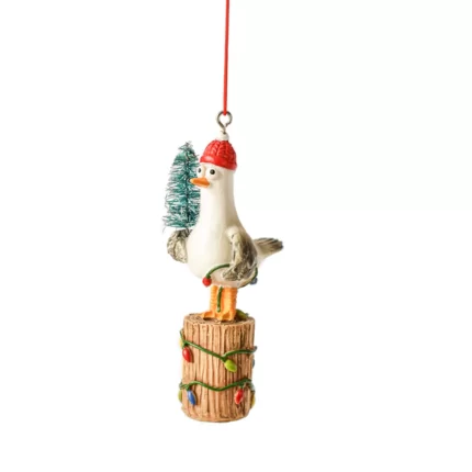 Seagull holding Christmas tree ornament
